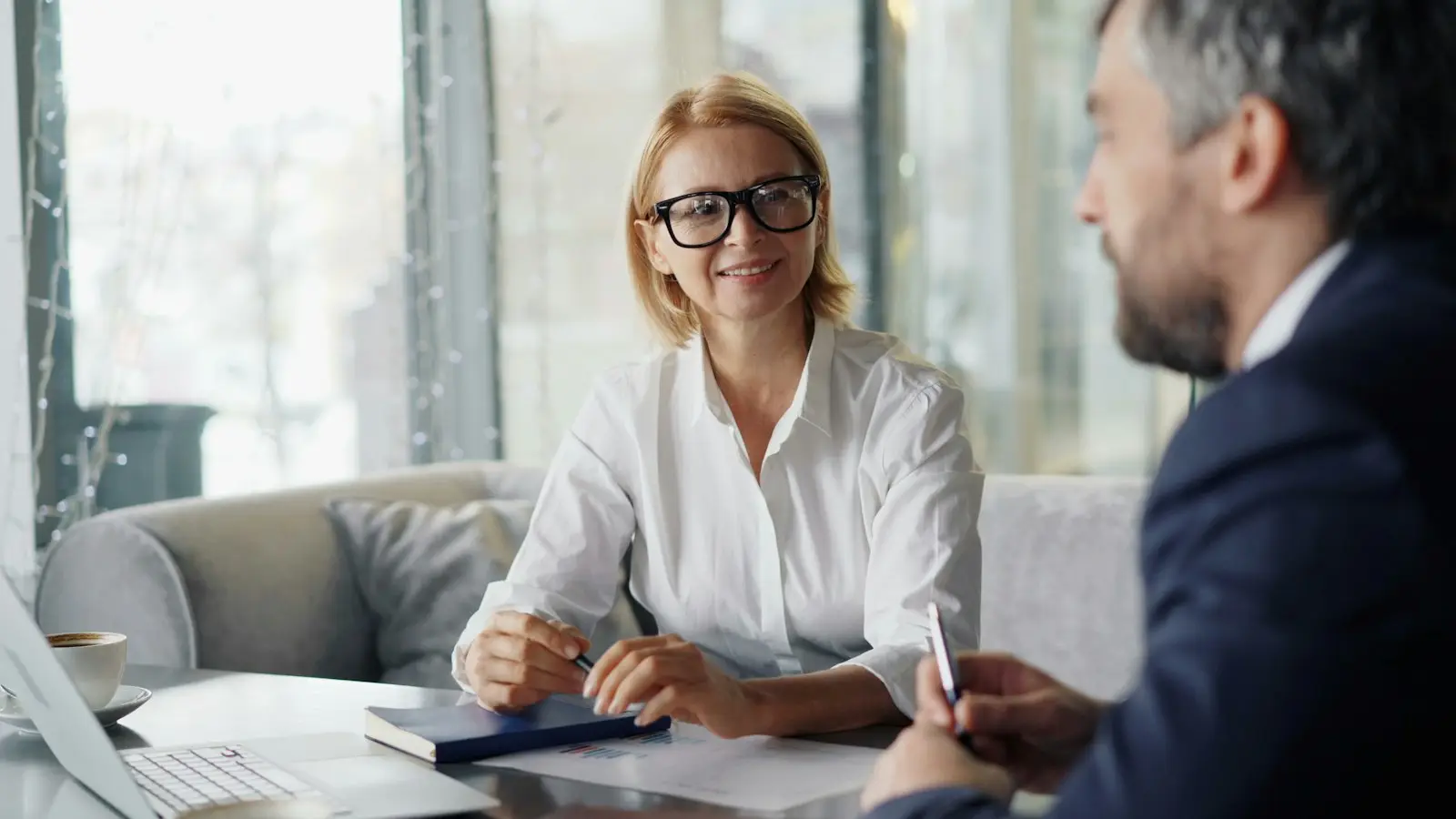 A client smiling while a specialist explains her options