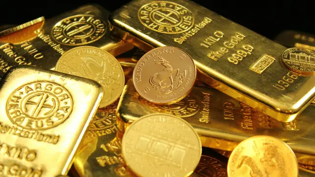 Gold bars stacked with gold coins