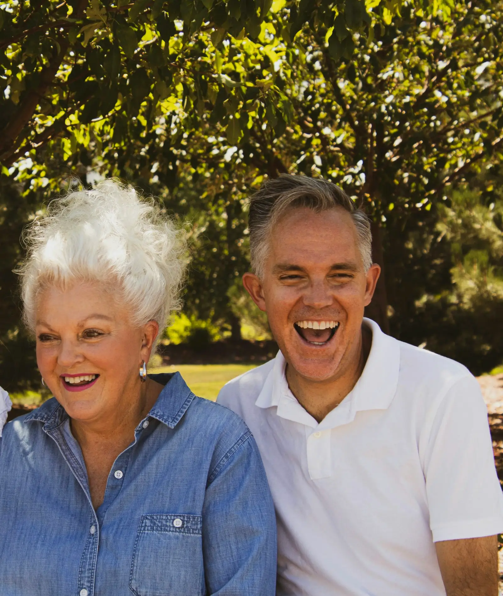 A retired couple laughing together outdoors